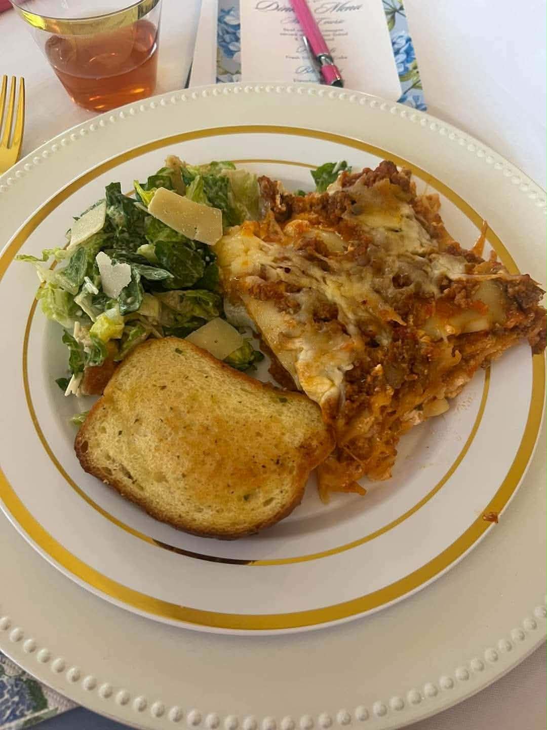 Plated lasagna with Caesar salad