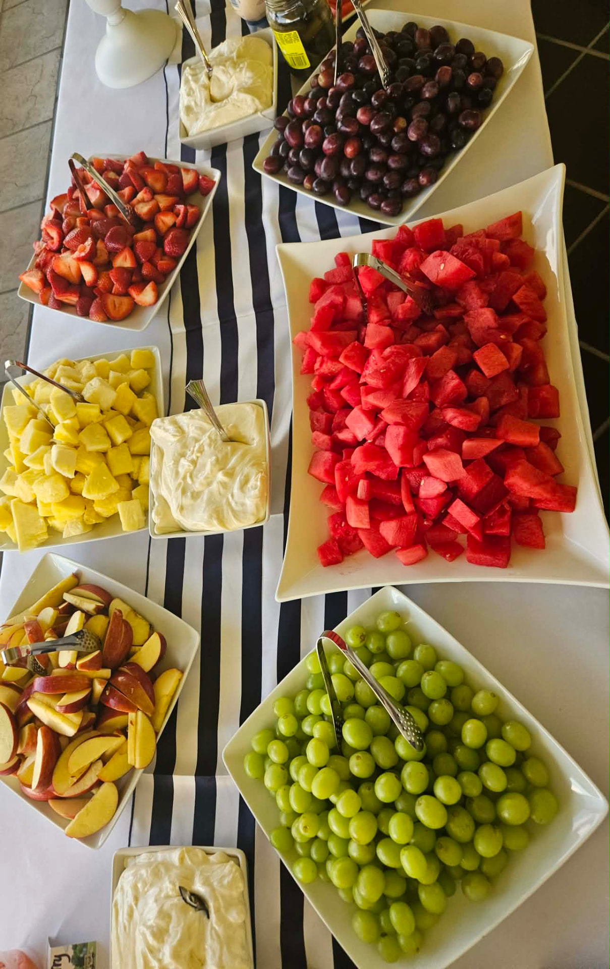 Cater It breakfast spread with fresh fruit trays and fruit dip